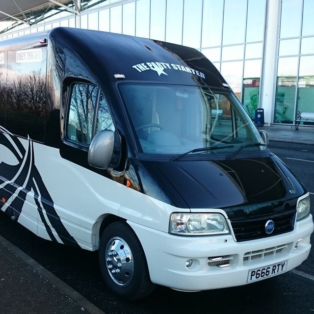 A partybus at an airport dropping off customer